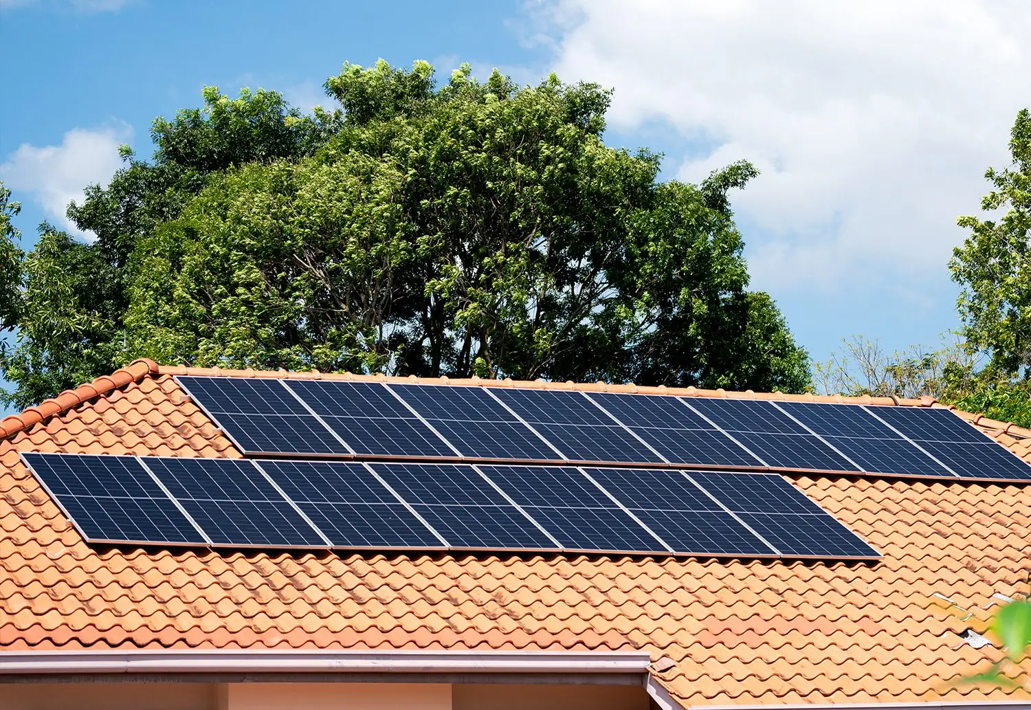 Residential solar panel array on tile roof in Florida sunshine