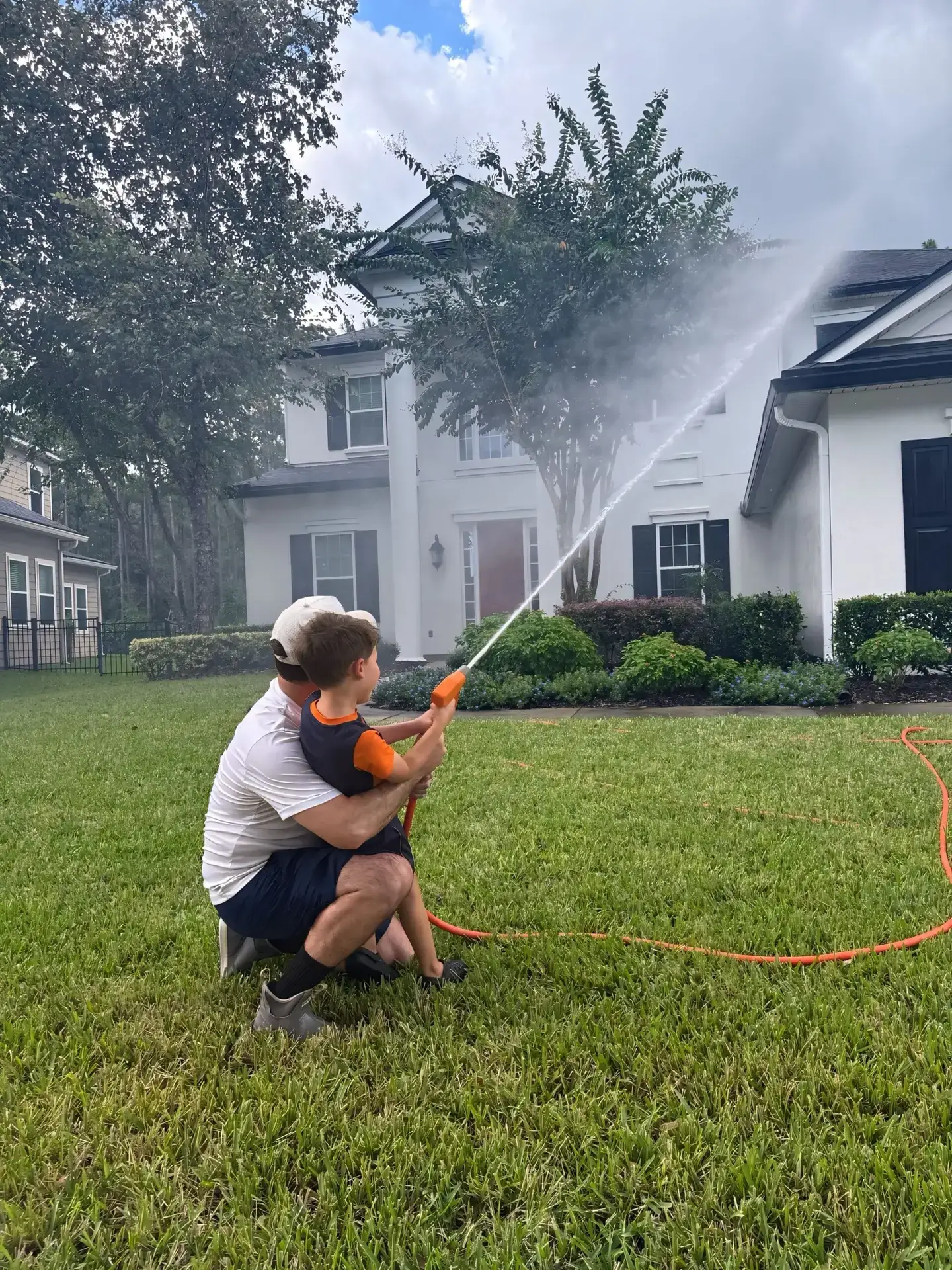 Professional soft wash exterior cleaning of residential patio and lawn area in Jacksonville, Florida